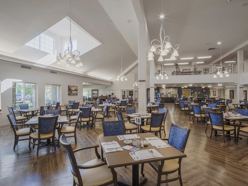 Spacious and elegant dining area with modern furnishings and chandeliers.