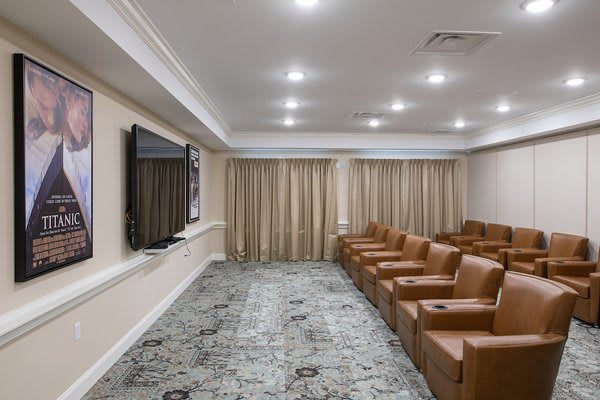 A modern conference room with comfortable seating and a large television screen.