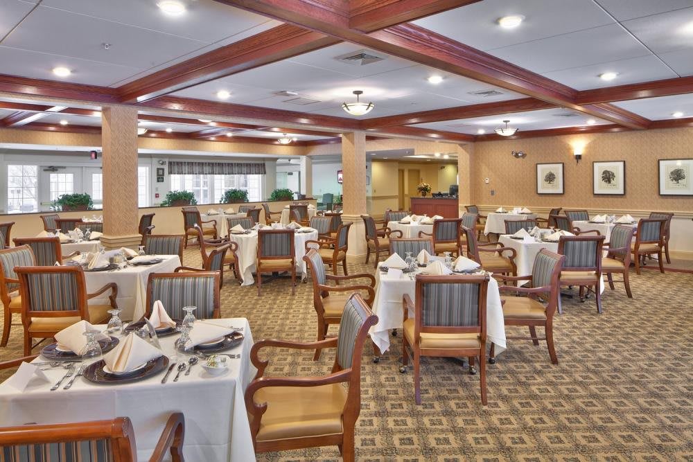 An elegant restaurant dining room with neatly arranged tables and chairs.