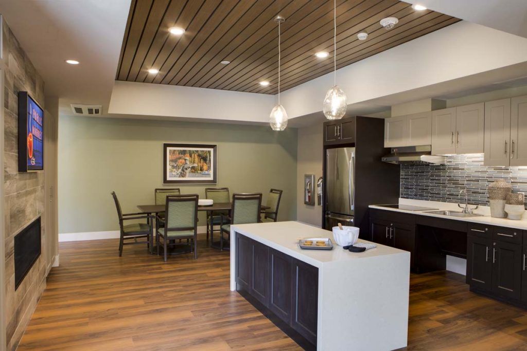 Modern kitchen and dining area with sleek design and wooden accents.