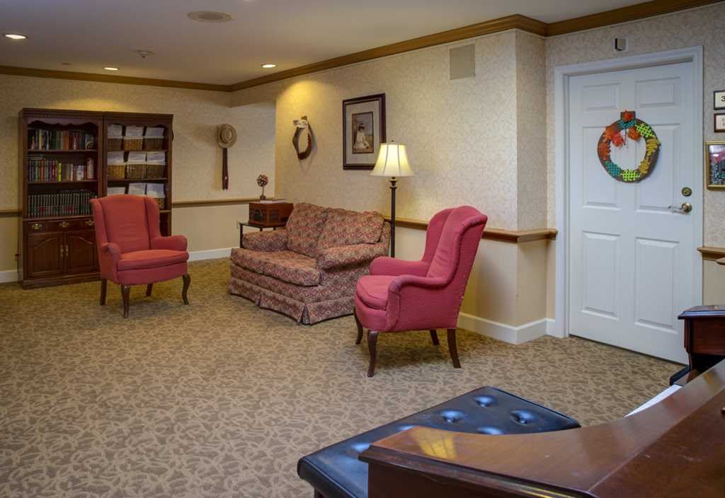 A cozy living room with comfortable seating and a bookshelf.
