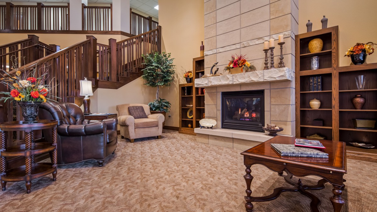 A cozy living room with a fireplace and comfortable seating.