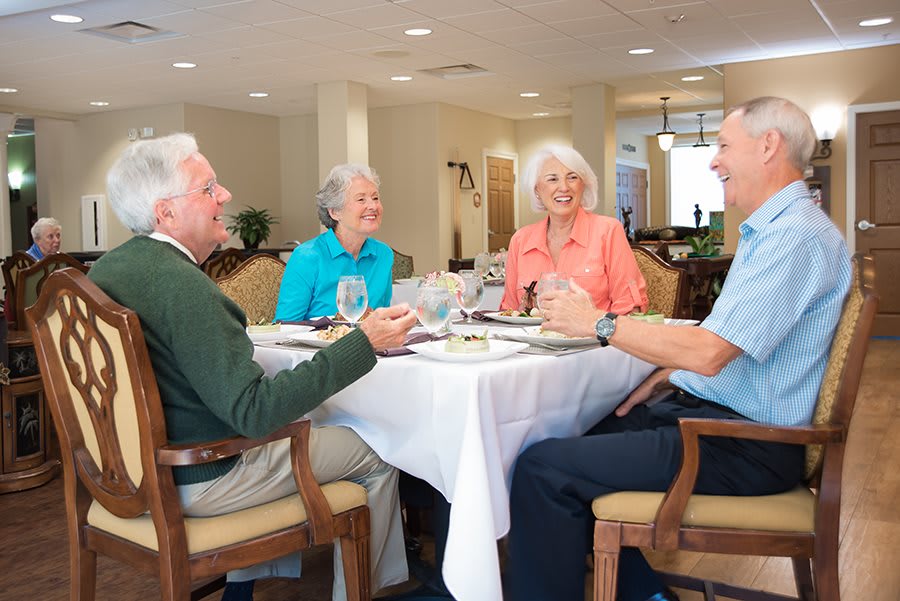 A group of seniors enjoying a meal together at a restaurant.