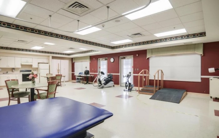 A rehabilitation center exercise room equipped with various fitness machines and therapy equipment.