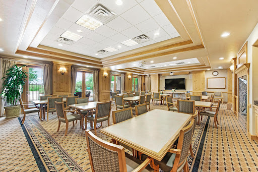A spacious and elegantly designed dining area with tables and chairs, perfect for social gatherings.