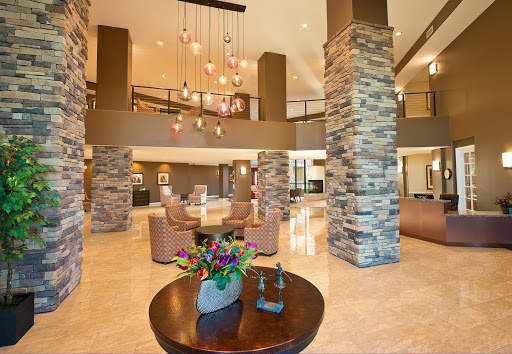 A welcoming lobby featuring modern design elements, stone pillars, and elegant lighting.