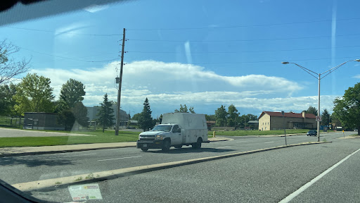 A white van parked on the roadside under a clear blue sky.