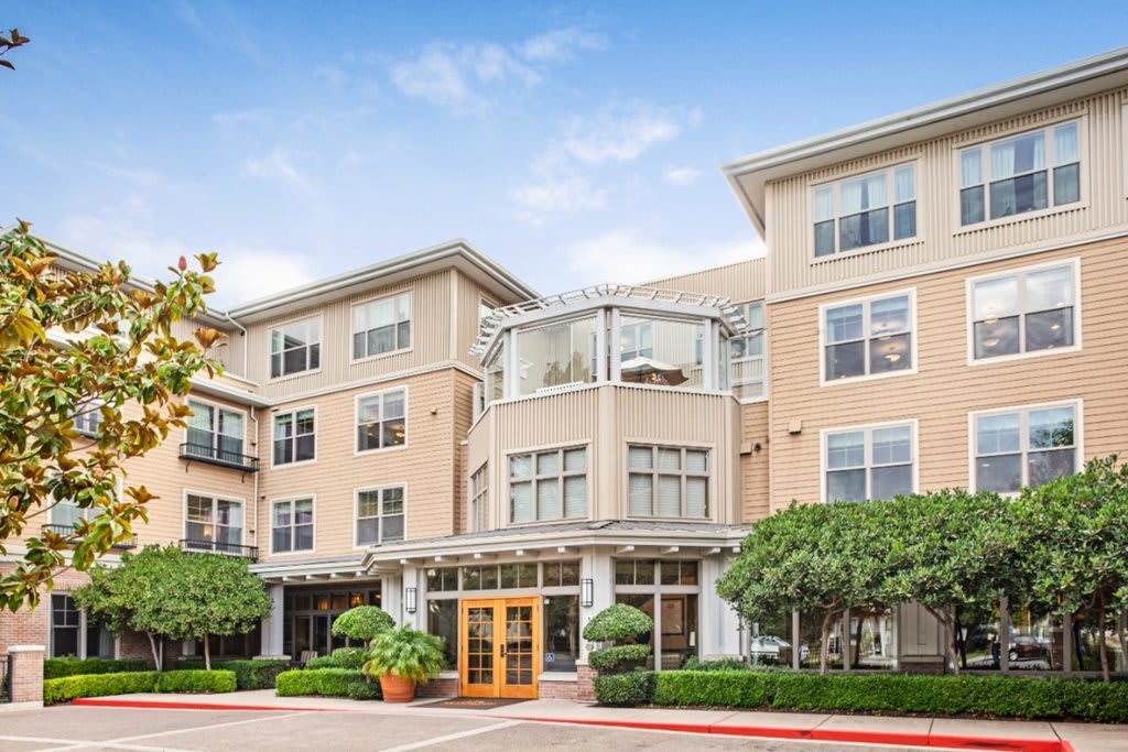 A modern apartment building with a welcoming entrance and well-maintained landscaping.