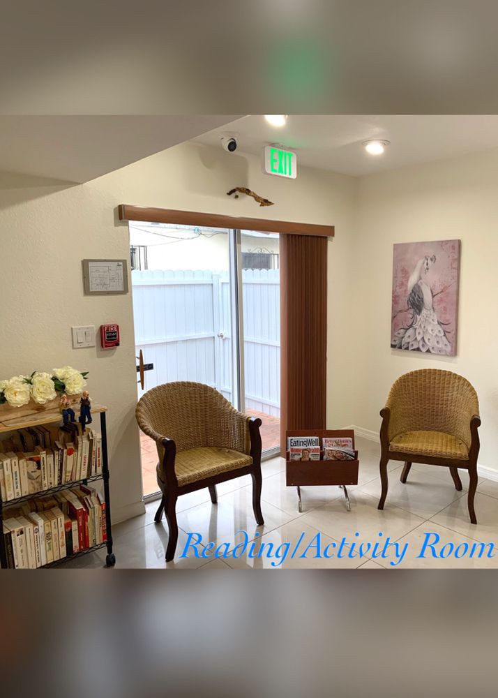 A cozy waiting room with chairs and a bookshelf.