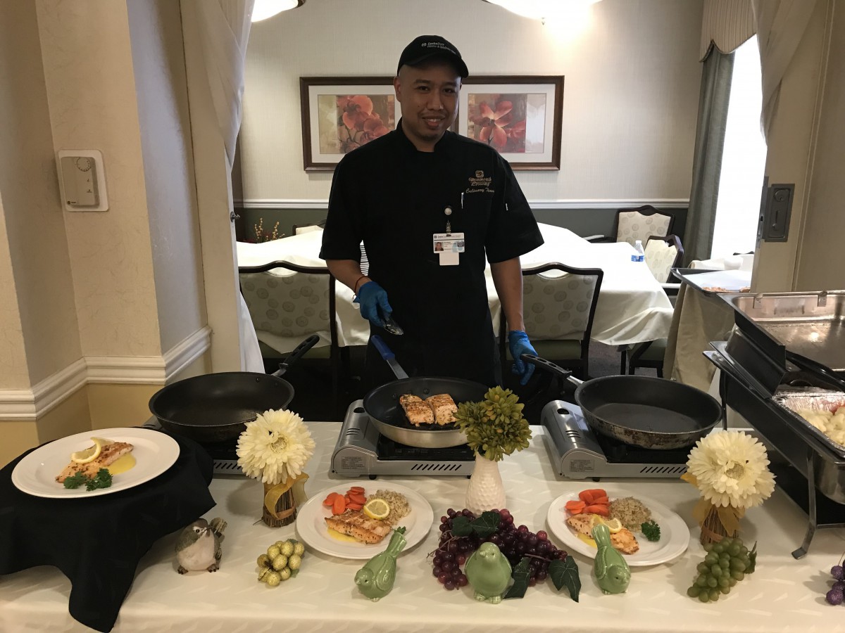 A chef prepares a meal at a well-arranged table, showcasing culinary skills.