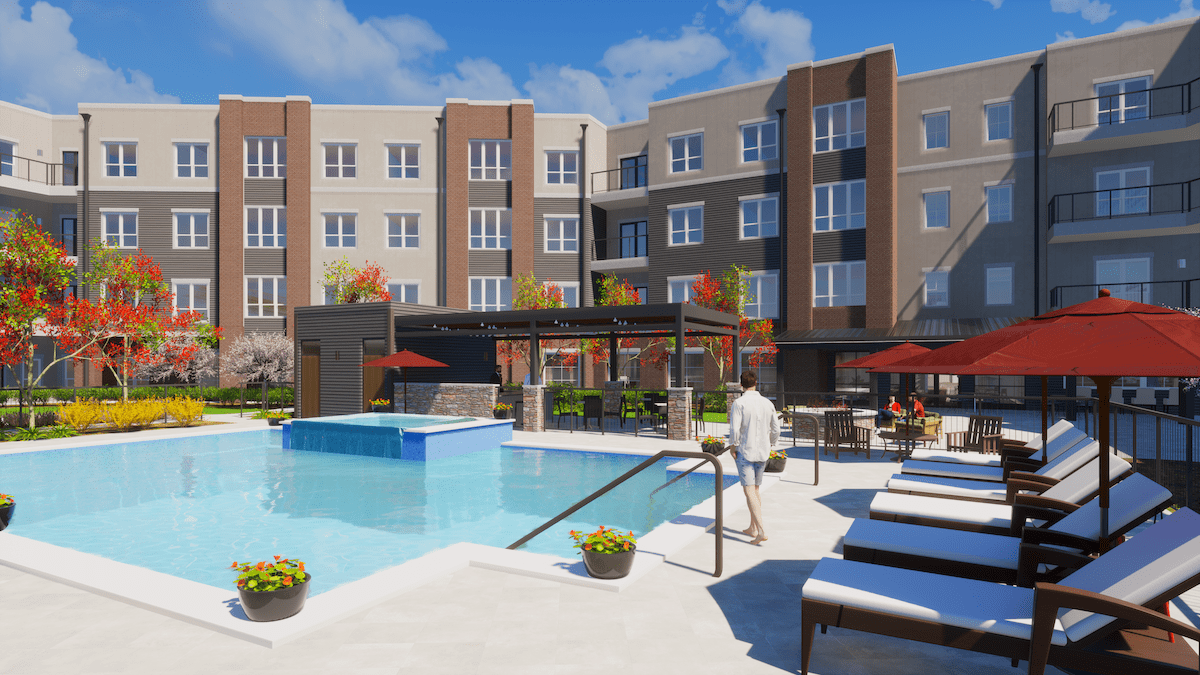 A modern apartment complex featuring a swimming pool and outdoor seating area on a sunny day.