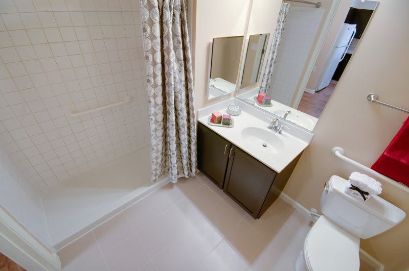 A clean and modern bathroom with a shower curtain, vanity, and sink.