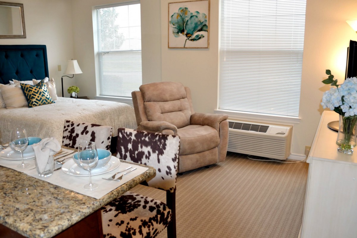 A cozy living room with a recliner and natural lighting.