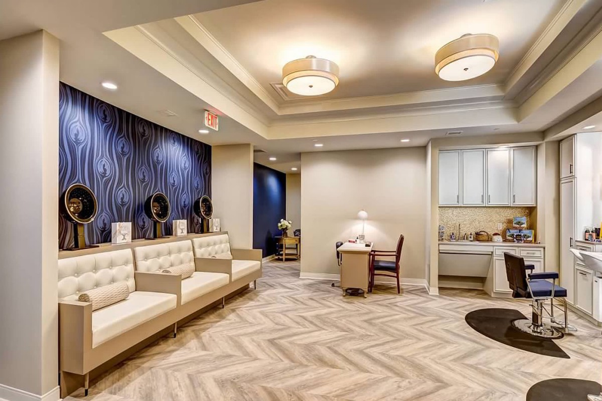 A modern waiting room with comfortable seating and stylish lighting.