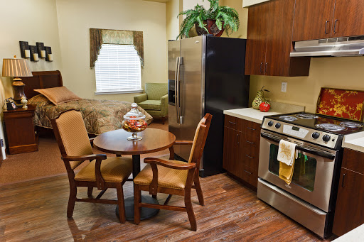 A cozy kitchen area featuring modern appliances and a small dining setup.