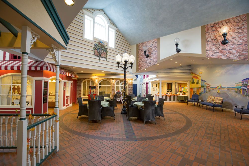 A cozy indoor dining area with wicker seating and a lamppost, featuring charming architecture and a brick floor.