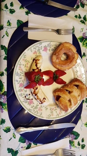 An elegantly presented plate featuring pastries and fresh strawberries.