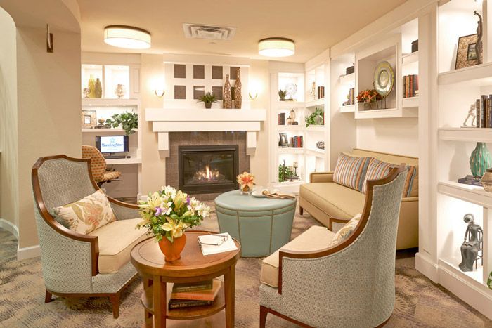Cozy living room with a warm fireplace and elegant decor.