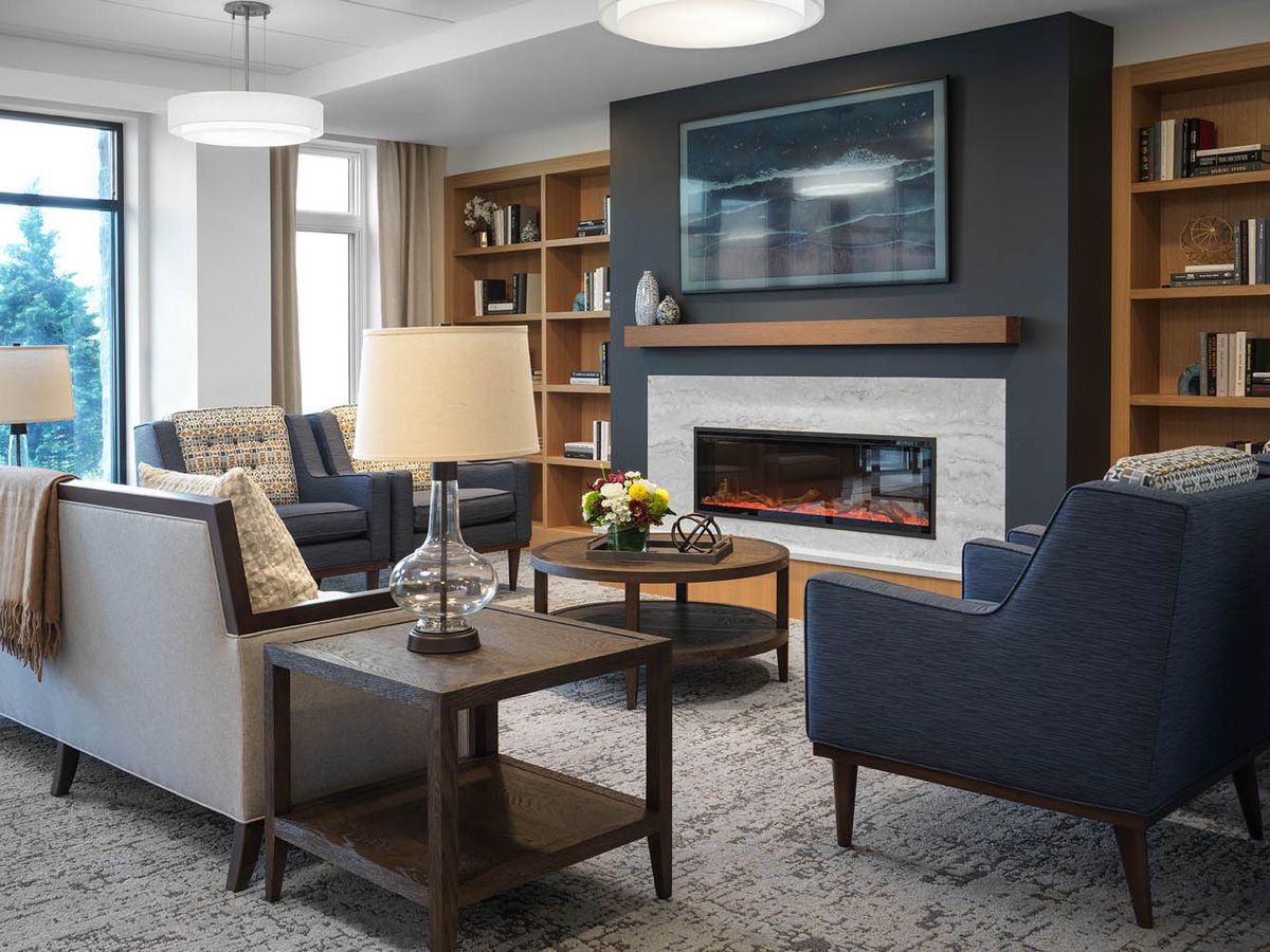A modern living room with a fireplace and stylish furnishings.