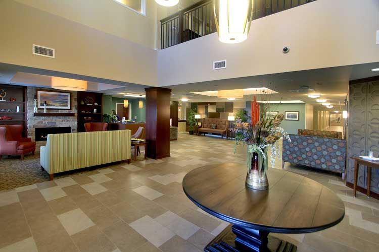A spacious hotel lobby featuring modern decor and comfortable seating areas.