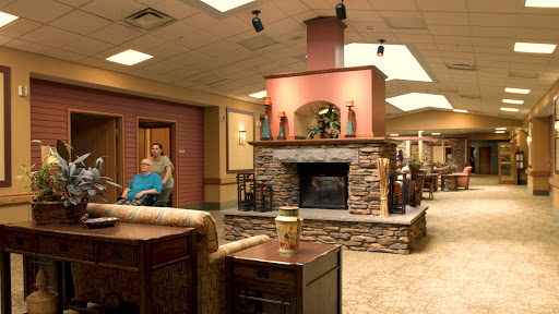 A welcoming lobby with a stone fireplace, providing a cozy environment for residents and visitors.