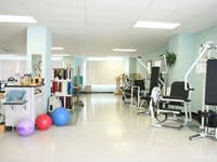 A well-equipped gym with various exercise machines and fitness equipment.
