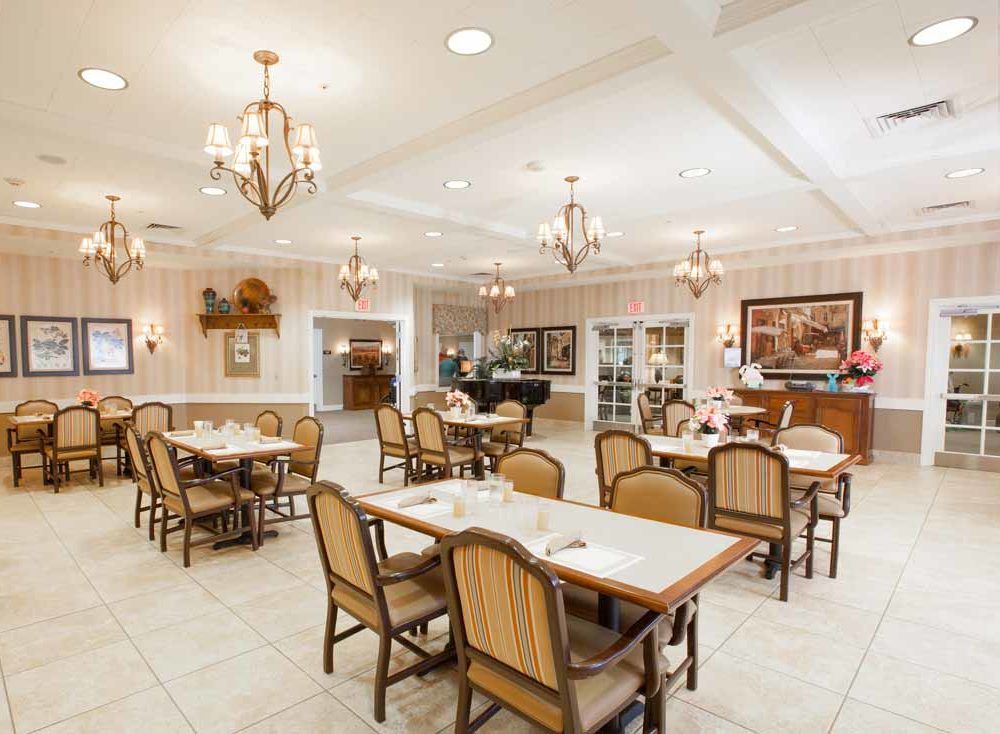 An elegantly decorated dining room with neatly arranged tables and chairs.