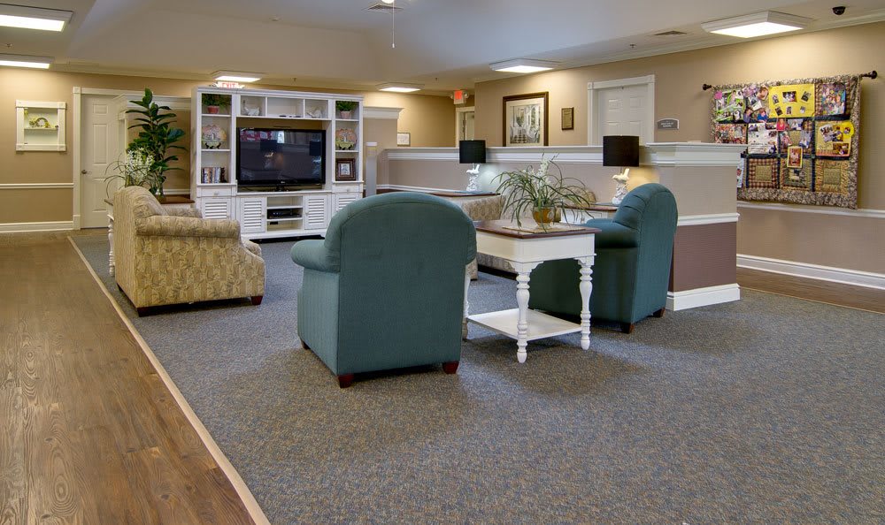A cozy living room setup with comfortable chairs, coffee table, and a television.