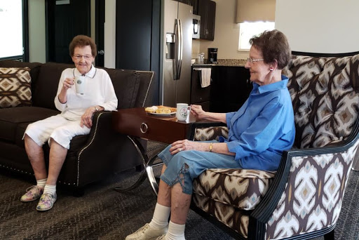 Two friends enjoying a cozy conversation in a warm, inviting setting.