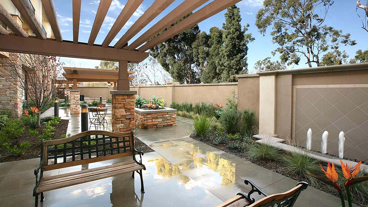 Beautiful outdoor patio area with a pergola and well-maintained garden.