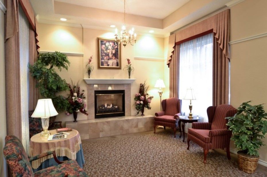 An elegantly decorated living room featuring a fireplace, seating area, and tasteful lighting.