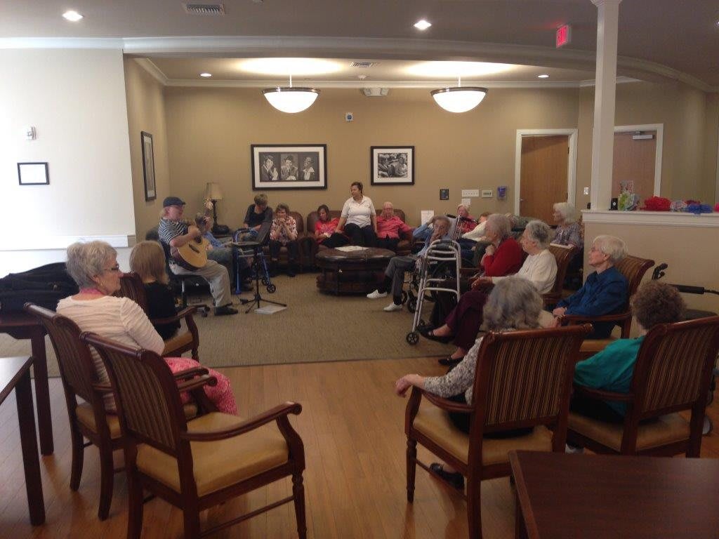 A group of seniors gathered in a communal space for an indoor activity.