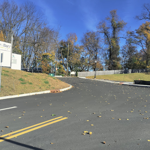 A scenic view of a winding road surrounded by trees with autumn leaves.