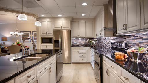 A modern kitchen featuring sleek cabinetry, stainless steel appliances, and elegant lighting.