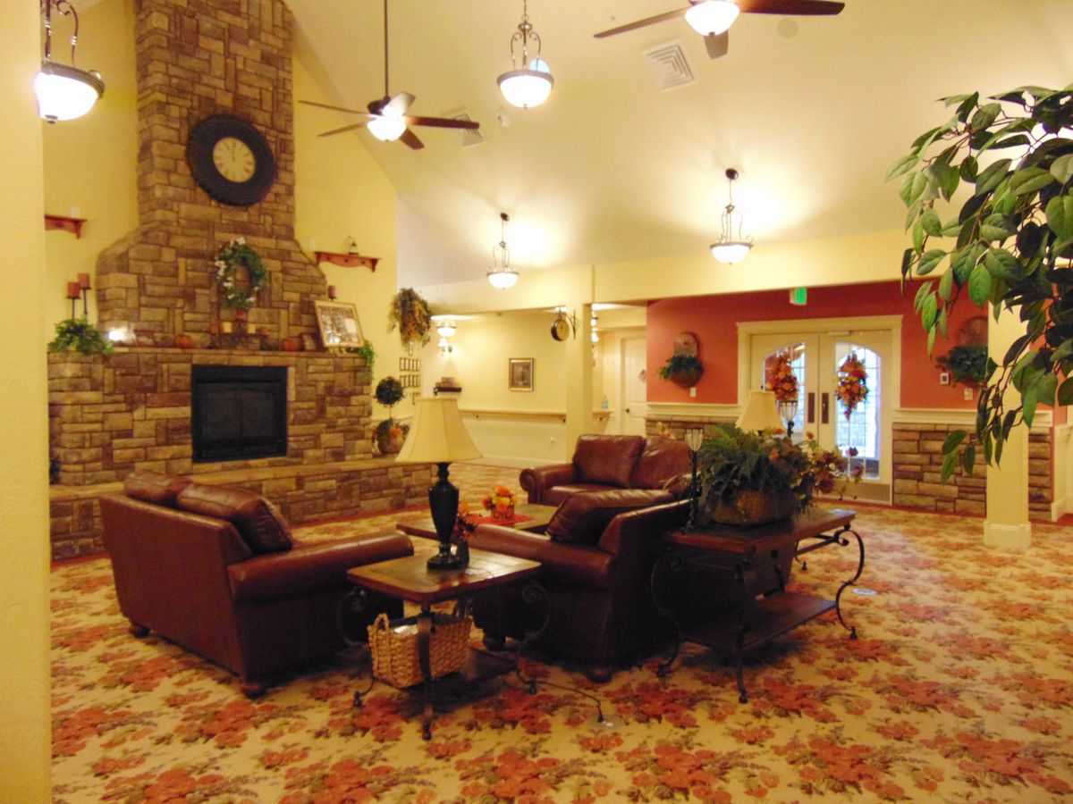 A cozy living room with a fireplace and comfortable seating.