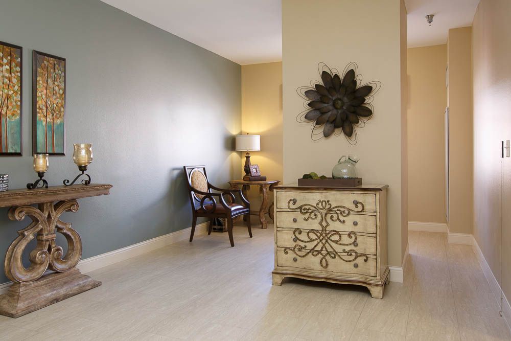 A cozy living room corner featuring vintage furniture and decorative wall art.