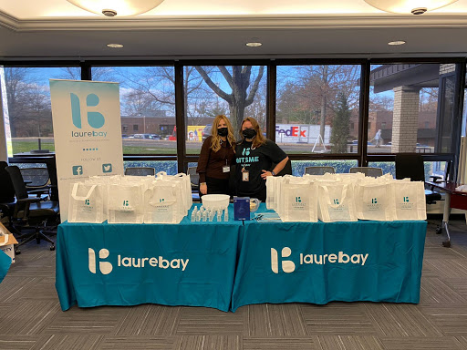 Team members at a promotional booth showcasing their company products and services.