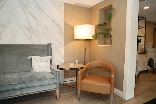 A cozy corner in a modern living room featuring stylish furniture and warm lighting.