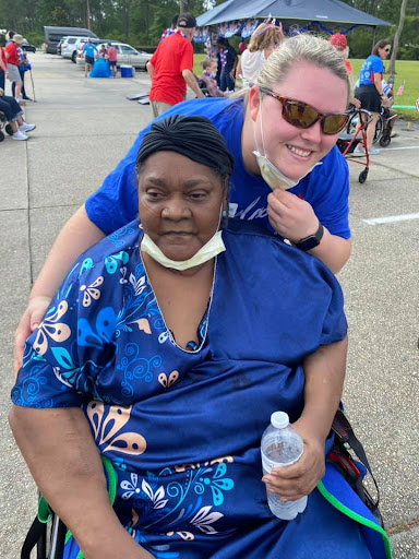 A joyful moment captured at a community event, showcasing friendship and support.