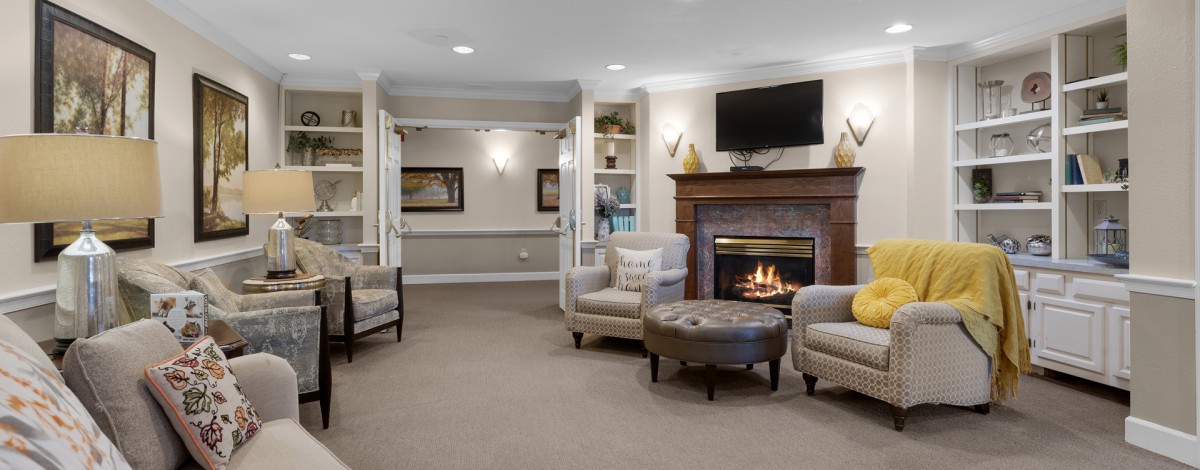 A cozy living room with a fireplace and comfortable seating.