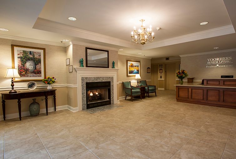 A cozy living room featuring a fireplace, chandelier, and comfortable seating area.