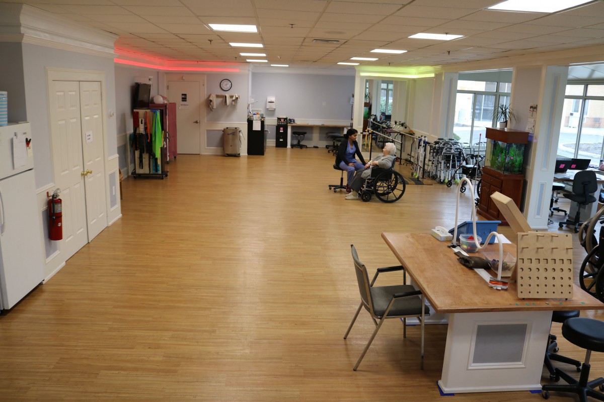 A spacious rehabilitation center equipped with various exercise machines and tools for physical therapy.