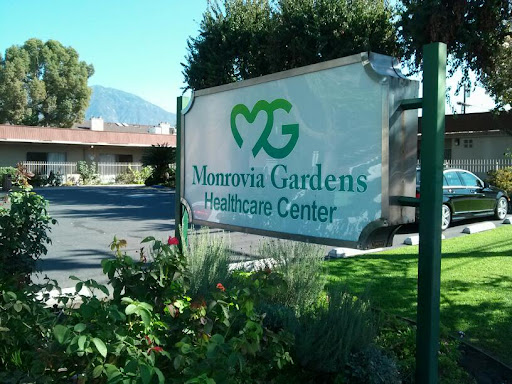 Monrovia Gardens Healthcare Center sign in a landscaped area.