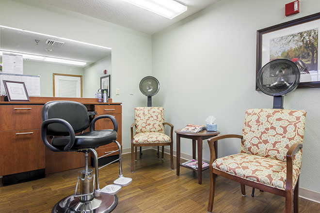 Cozy hair salon interior with a waiting area and styling station.