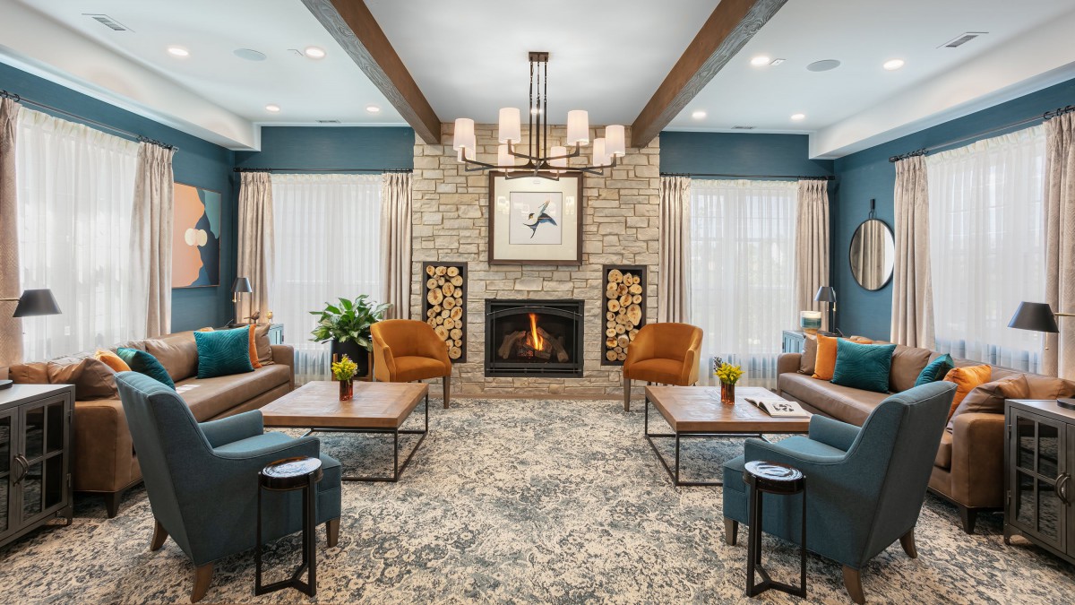 A modern living room featuring a cozy fireplace, comfortable seating, and elegant interior decor.