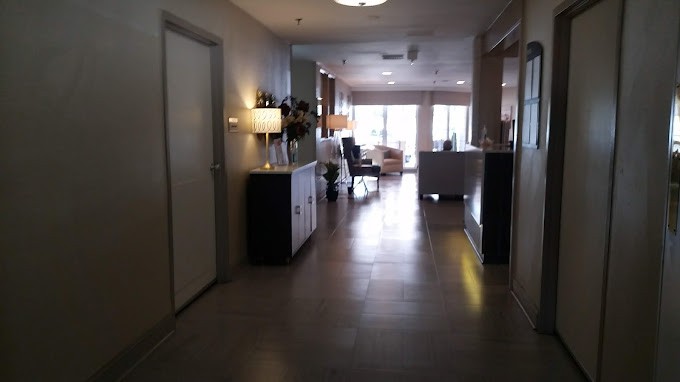 A modern hallway with stylish furniture and warm lighting.