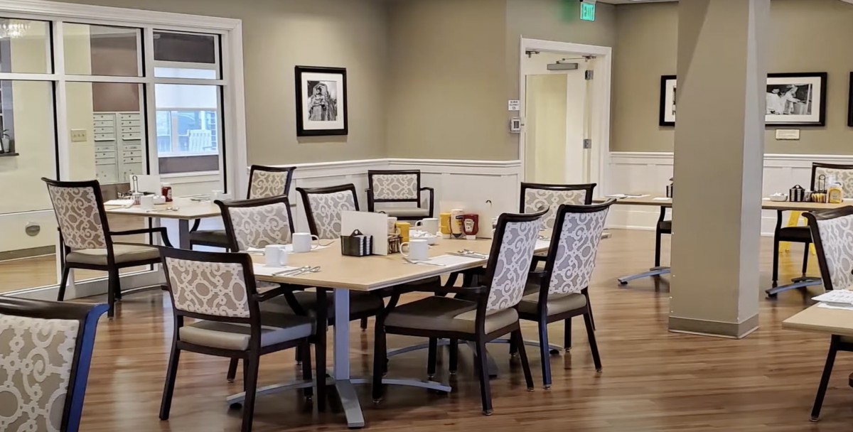 A well-arranged dining area with a set table and comfortable chairs.