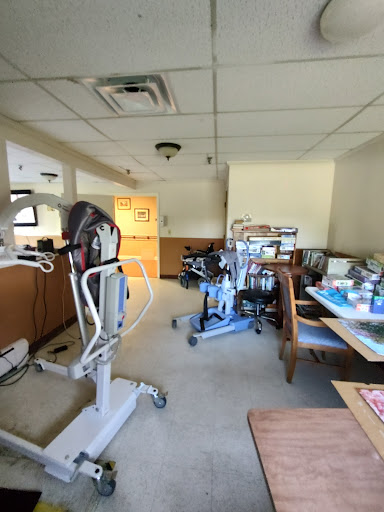 A view of a hospital room equipped with various medical and rehabilitation devices.