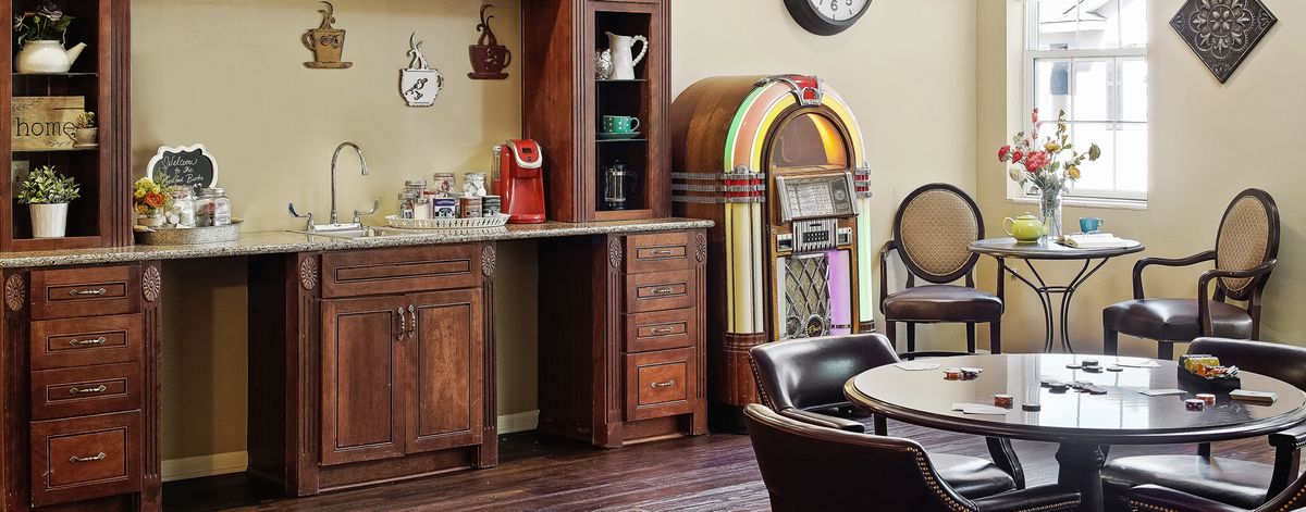 A cozy kitchen corner featuring a vintage jukebox and a modern coffee station.