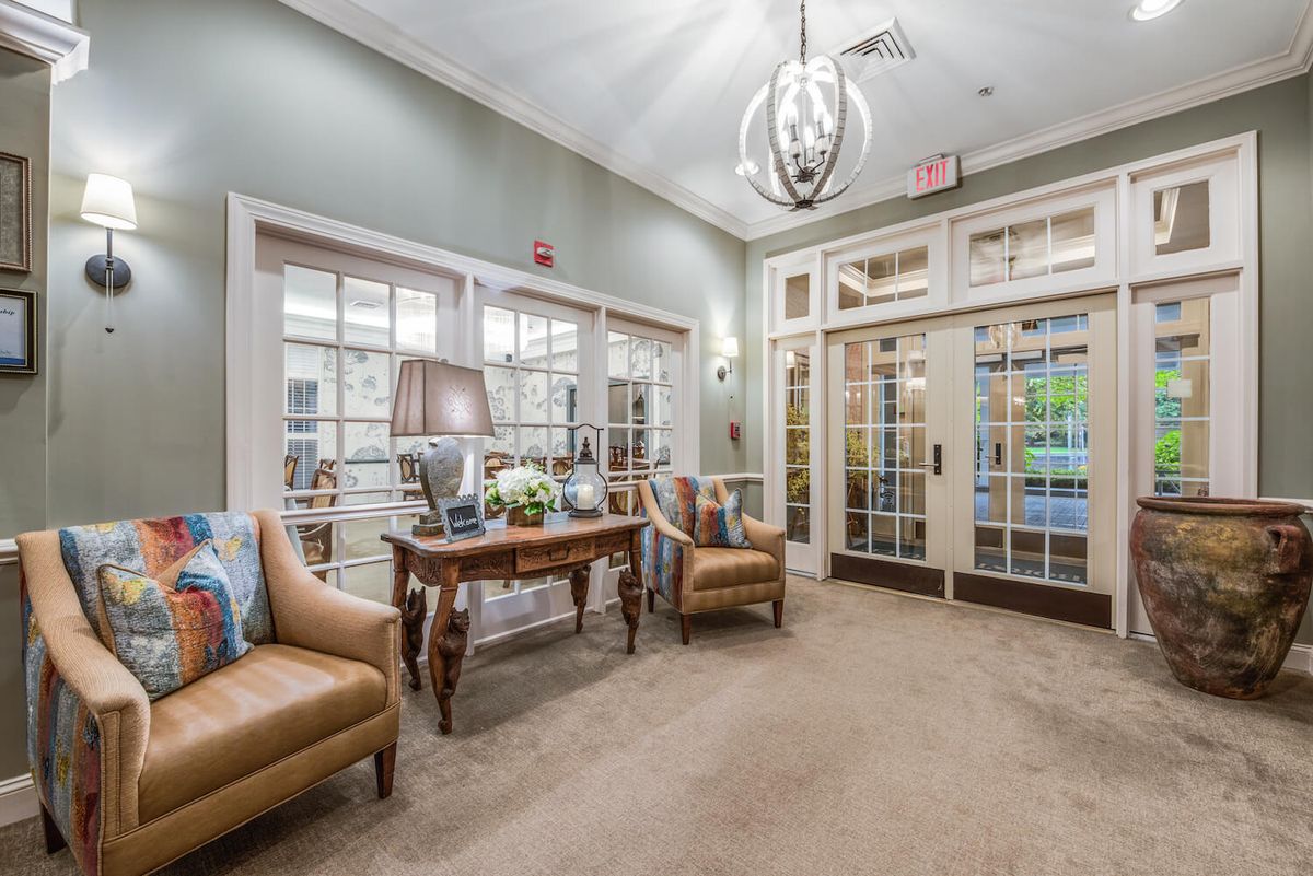 A well-lit lobby area with comfortable seating and elegant decor.